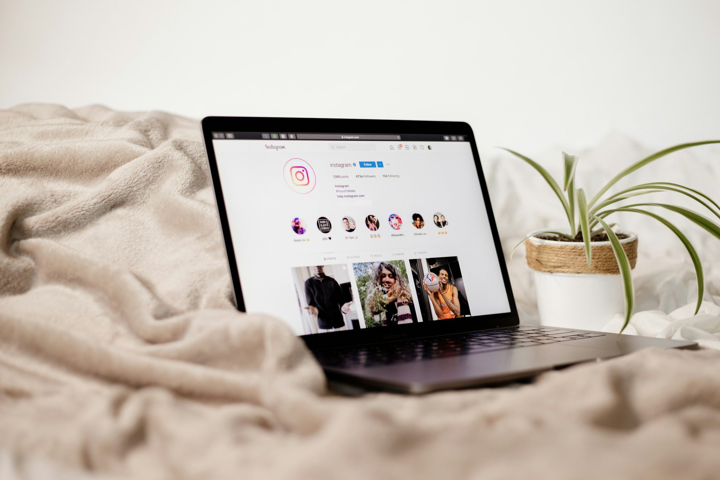 A laptop displaying social media content in a bright workspace