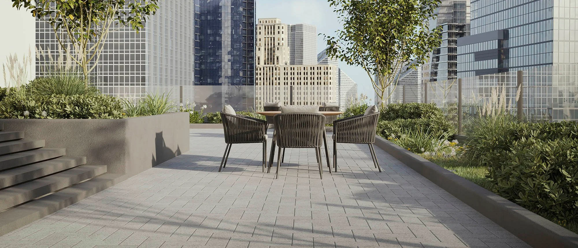Rooftop terrace with pavers, planters and patio seating surrounded by city buildings