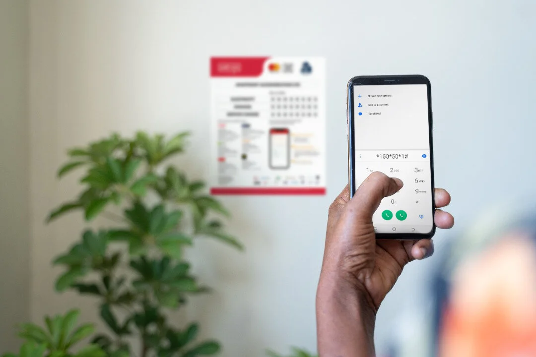 A tenant dials in the USSD short code to pay service charge and utility bills with Selcom Pay/Mastercard QR.