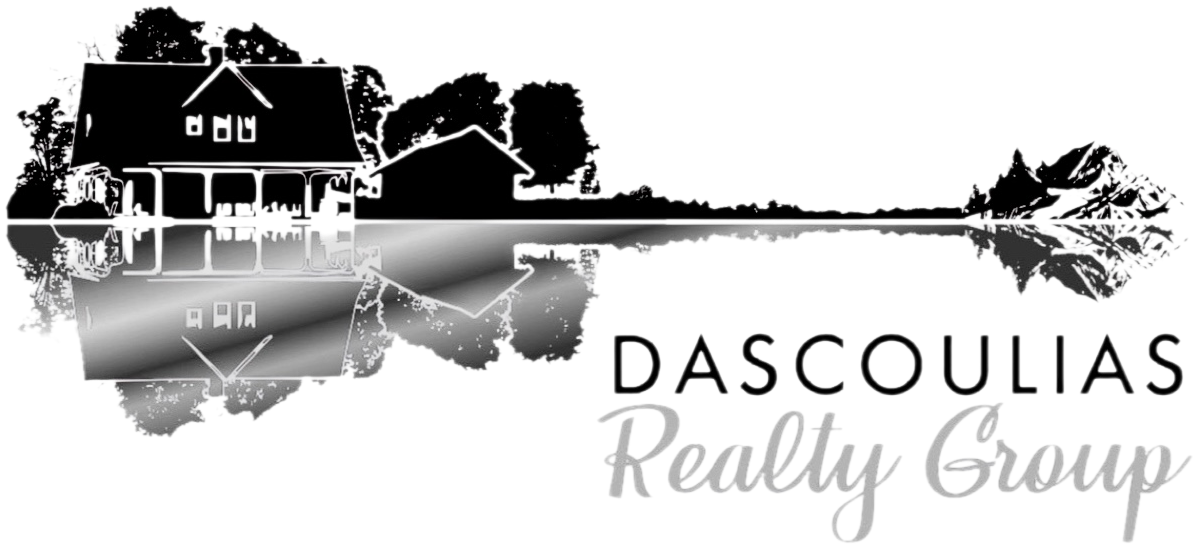 Silhouette of a house and trees reflected in a body of water with the text 'Dascoulias Realty Group' written below.