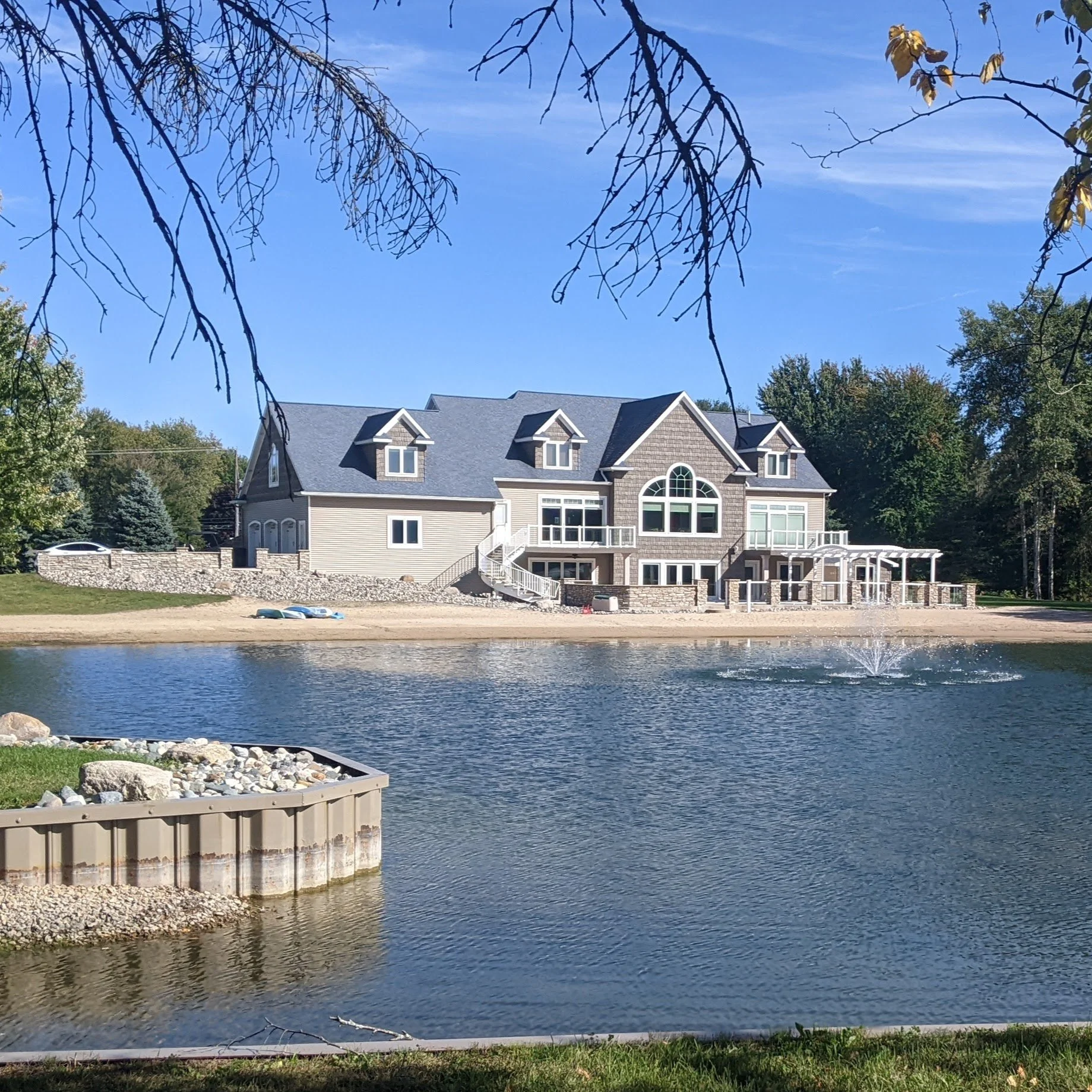 LARGE HOME ON BEACH WITH FOUNTAIN IN FORE GROUND