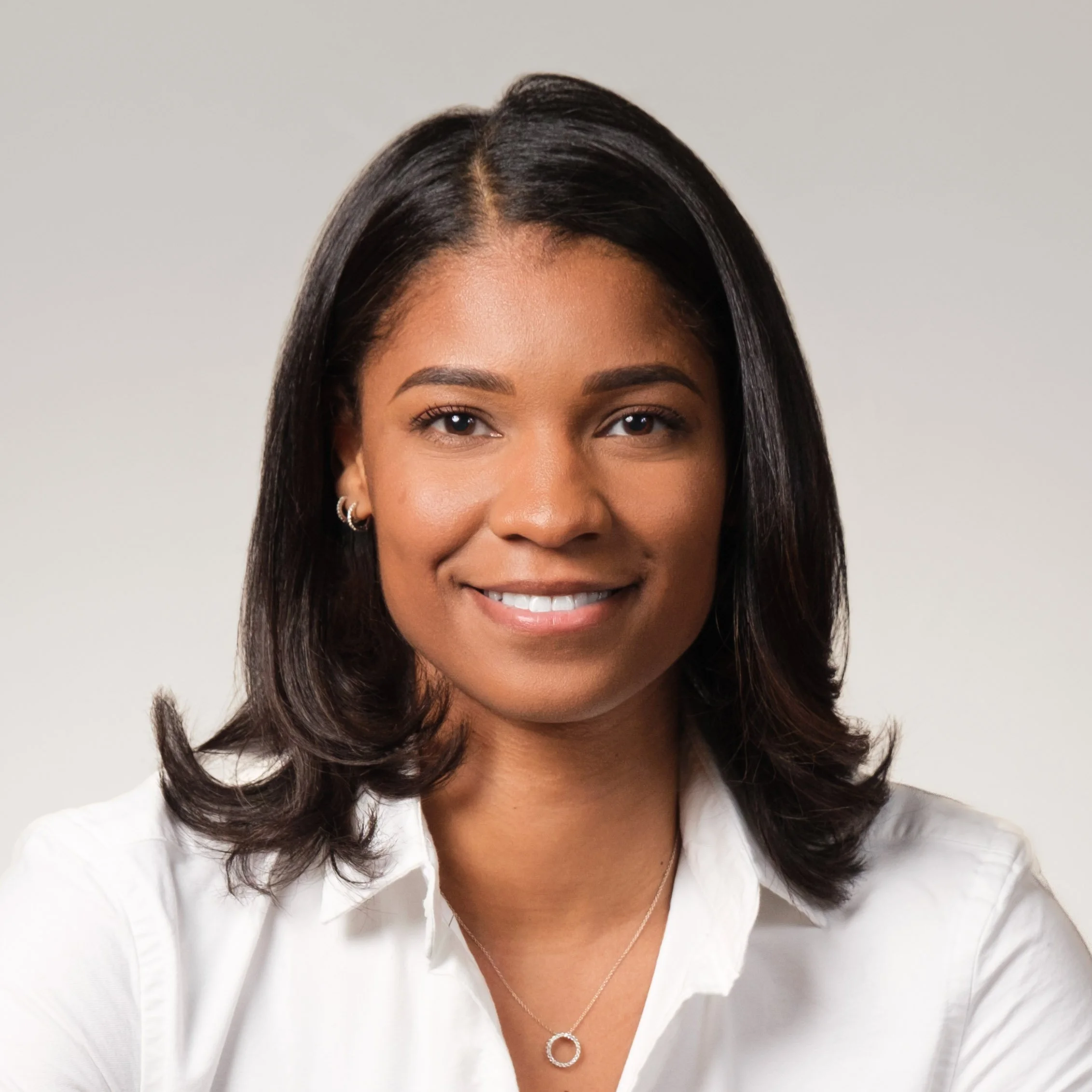 Female Corporate professional wearing a white top for her Headshot Session
