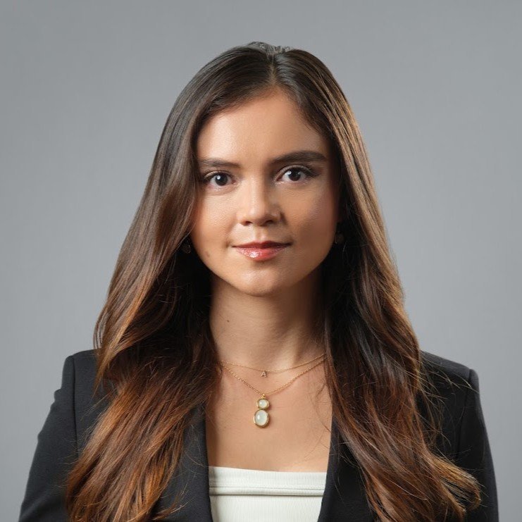 Female Corporate professional wearing a black suit jacket and white top for her Headshot Session
