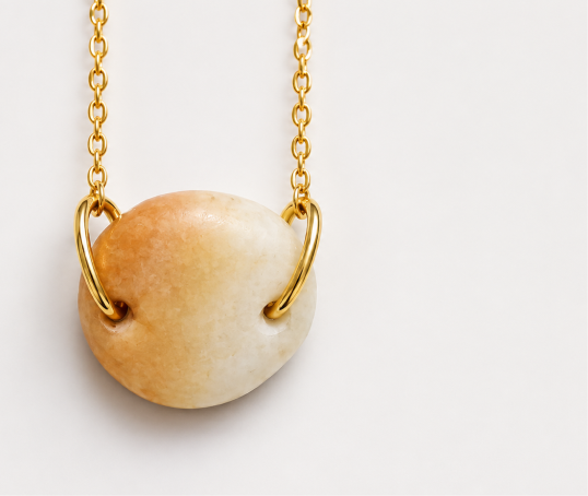 Gold chain necklace with a round stone pendant