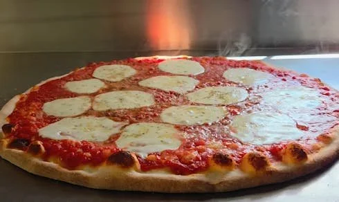 A freshly baked cheese pizza with tomato sauce and melted cheese on a round crust.