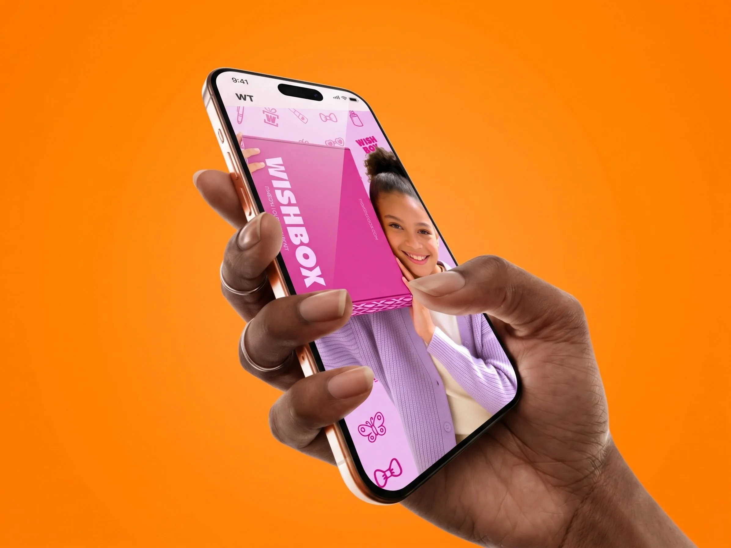 Wishbox mobile website mockup featuring a pink Wishbox package and branded unboxing imagery.