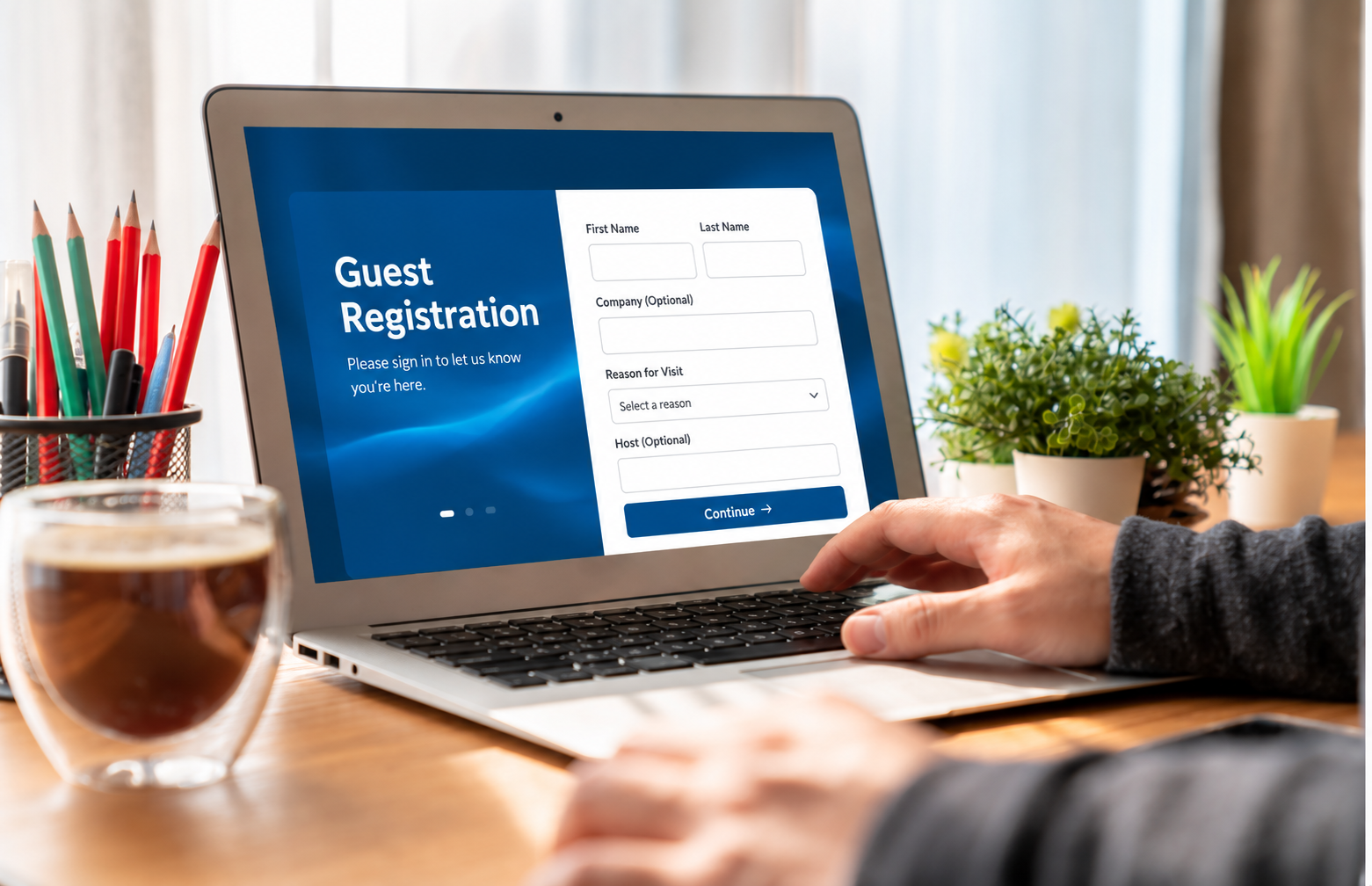 Laptop displaying a digital visitor registration form.