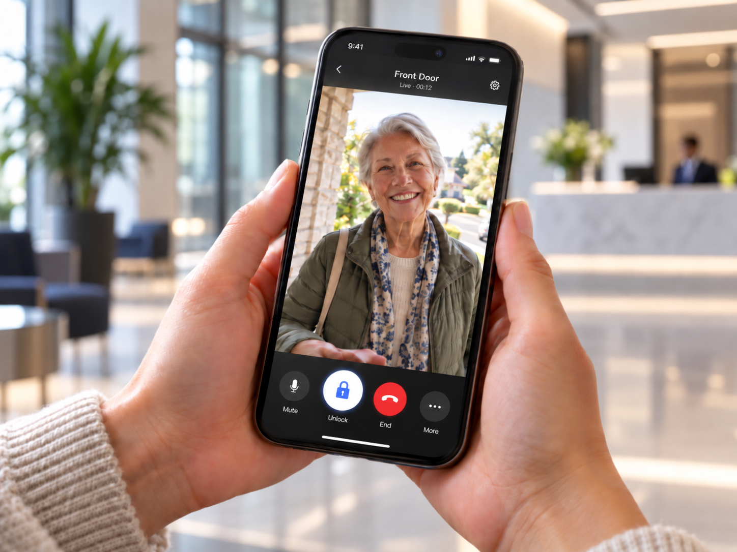 User viewing and remotely admitting a visitor through a mobile video intercom app.