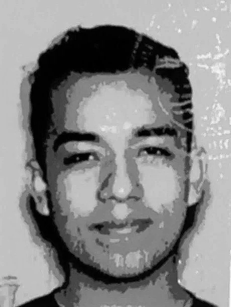 Black and white pixelated portrait of a young man smiling.