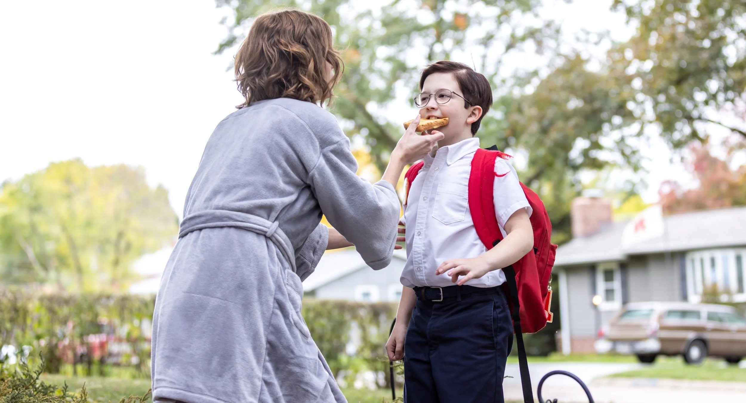 Victoria Blade, playing Mrs. Fitzpatrick, makes sure her young neighbor Jimmy, played by Matthew Lamb, doesn’t leave without breakfast in a scene from GOING FOR TWO.