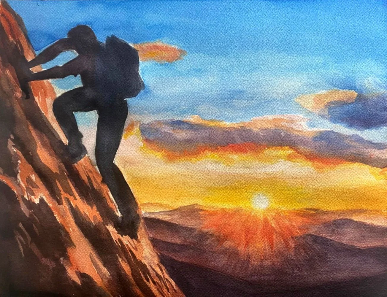 A silhouette of a person climbing a rocky hill or mountain at sunset, with a sky filled with clouds and vibrant orange, yellow, and blue colors.