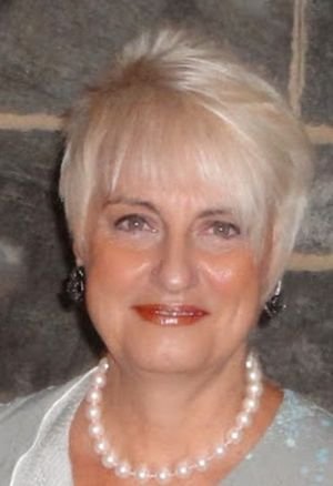 Gail Montgomery, co-author of Link to Vitality, smiling, with short blonde hair and a pearl necklace