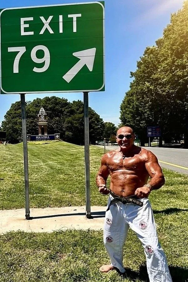 Nabil at age 79 beside an Exit 79 highway sign in Rock Hill, South Carolina