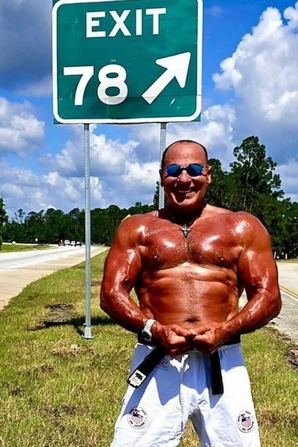 Nabil at age 78 beside an Exit 78 highway sign