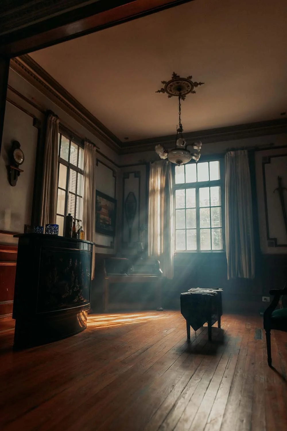 Quiet sunlit room with an empty chair, evoking absence and loss.