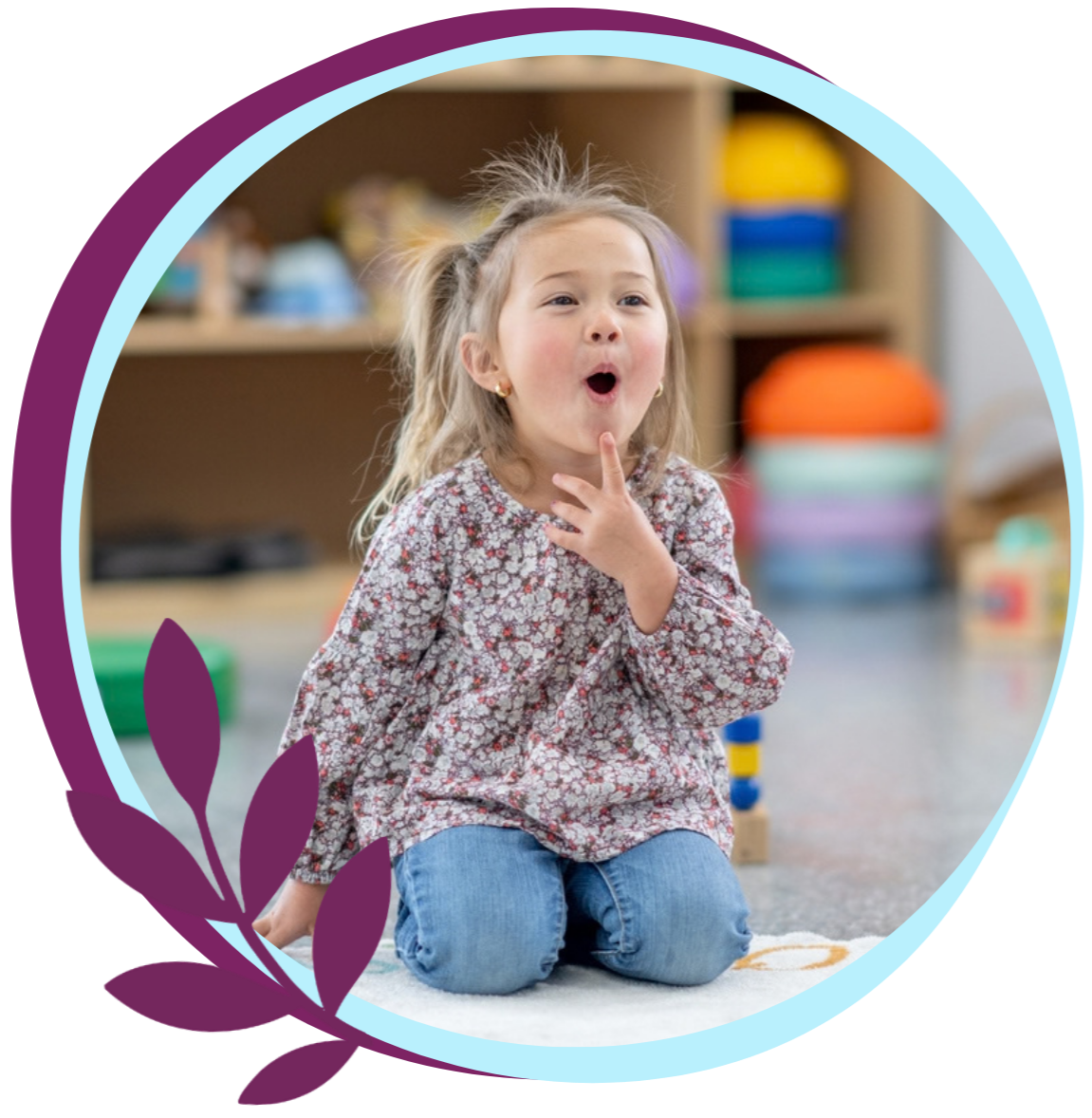 A young girl kneeling on the floor with her mouth open and finger touching her chin, working on making speech sounds correctly during in-home speech therapy for kids in Slidell, LA.