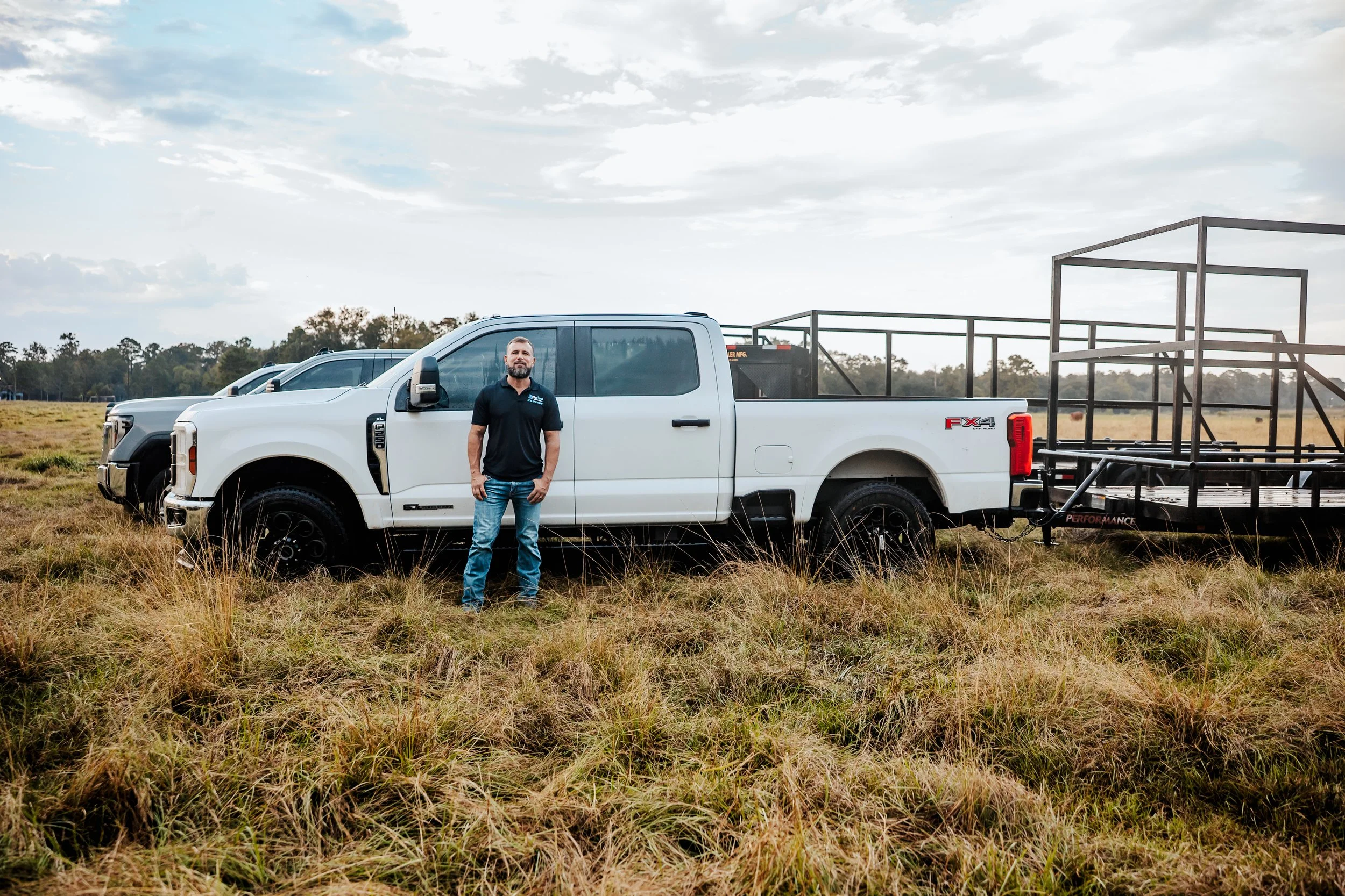 OnlyCans owner standing with company truck and trailer