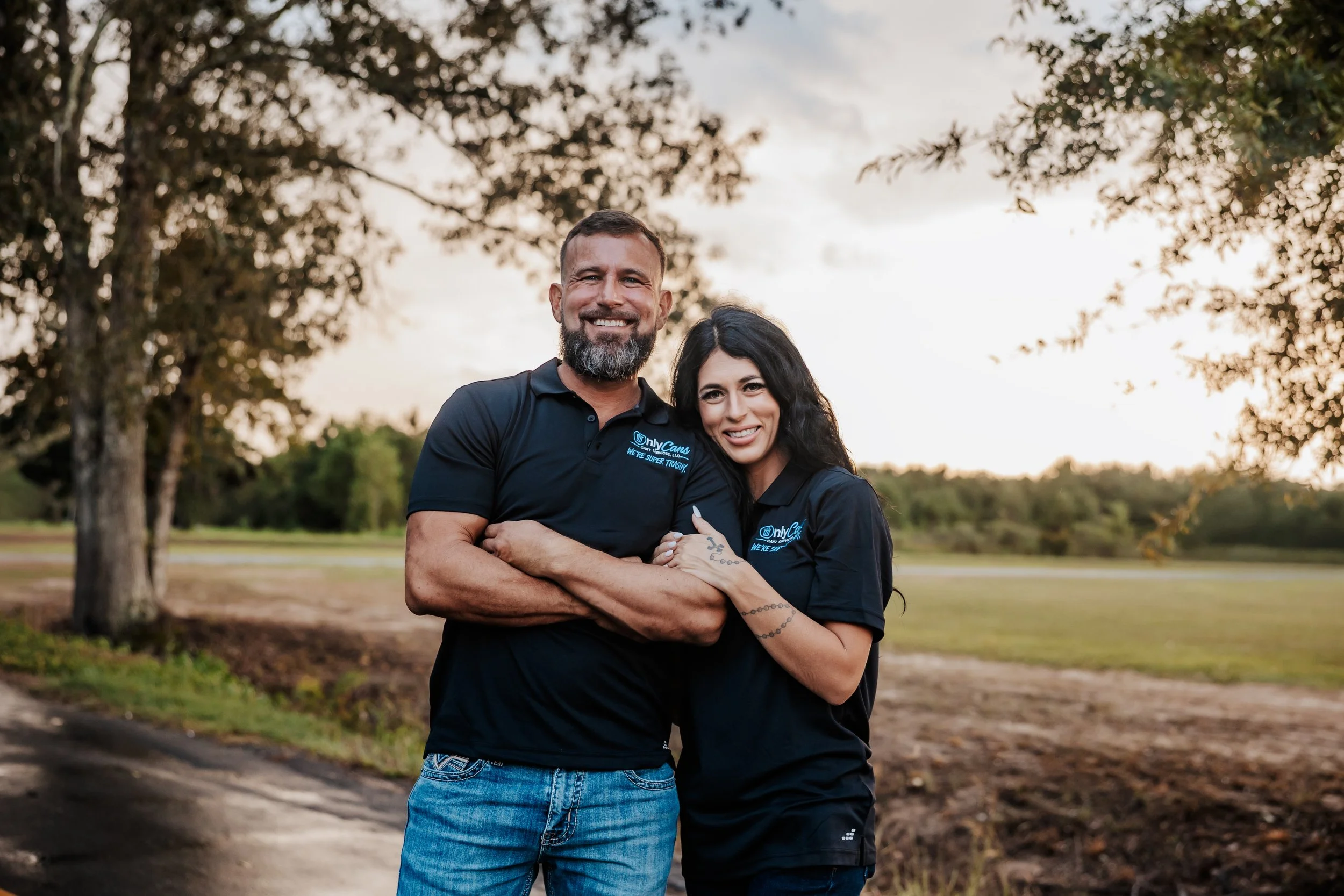 OnlyCans cart services owners outdoors with company shirts