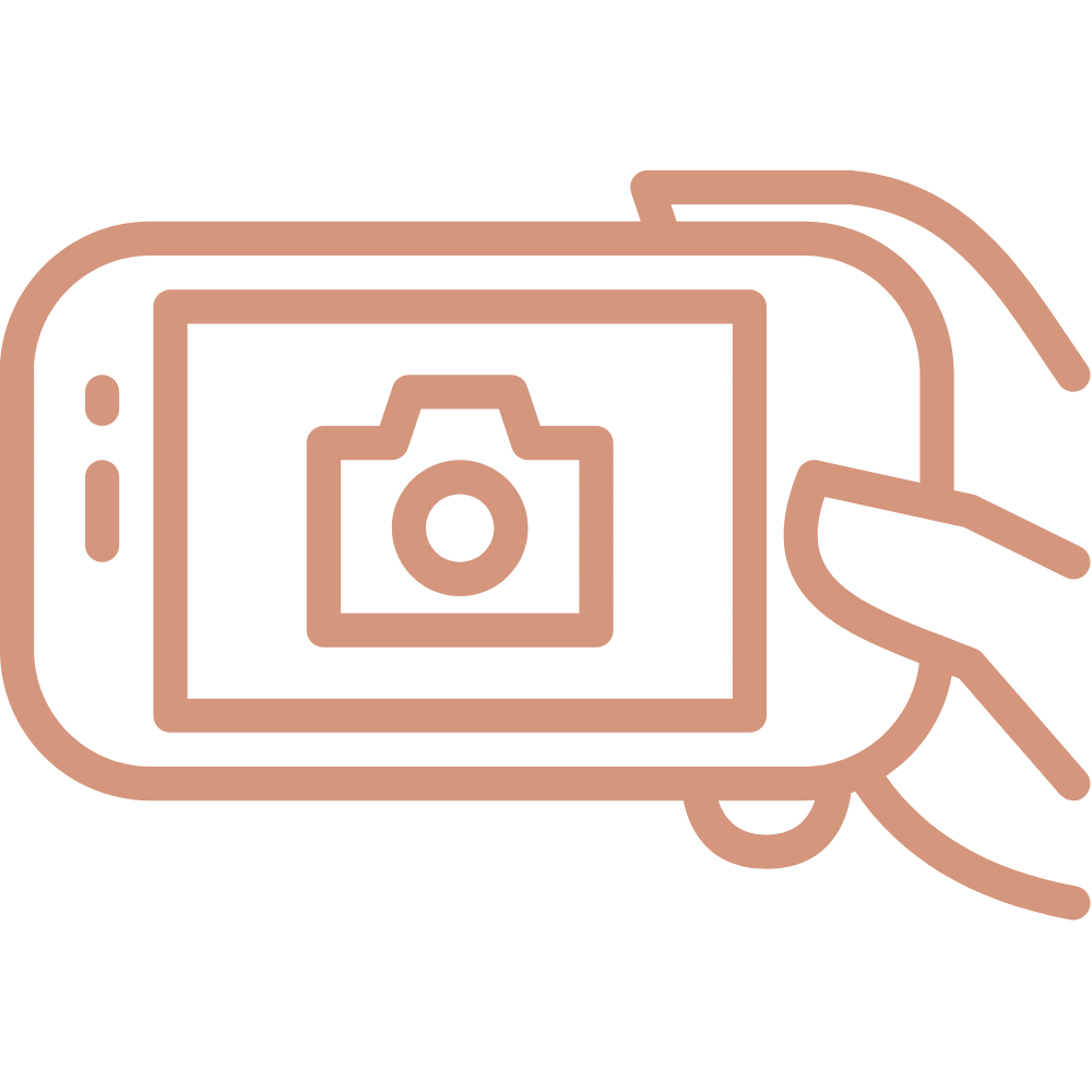 Outline of a smartphone with a camera icon on the screen, held by a hand.