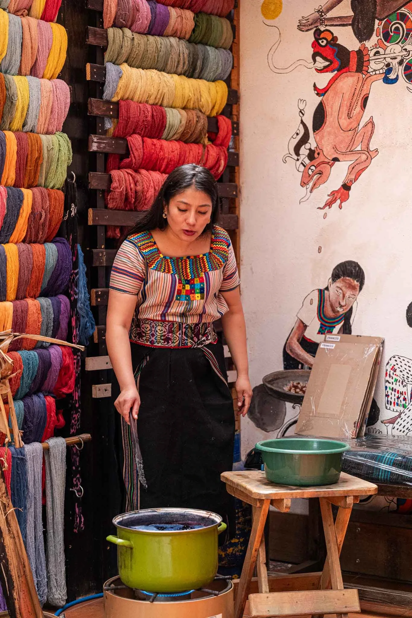 Maya woman in front of colorful fabric