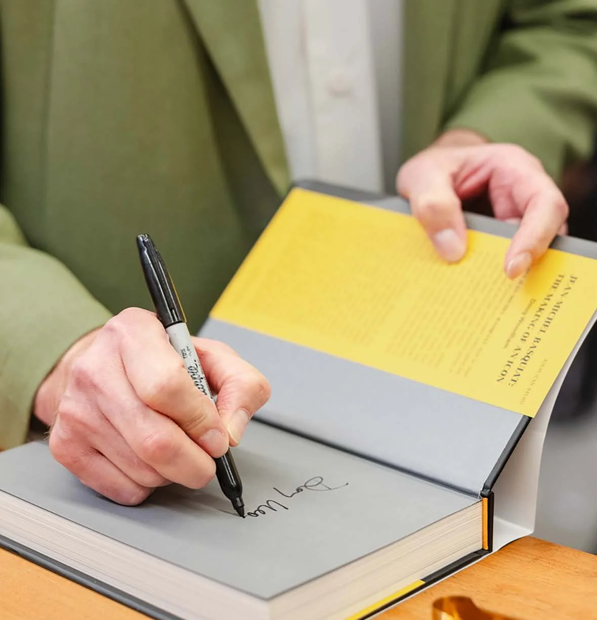 Doug Woodham signing his book Jean-Michel Basquiat: The Making of an Icon at a book signing event