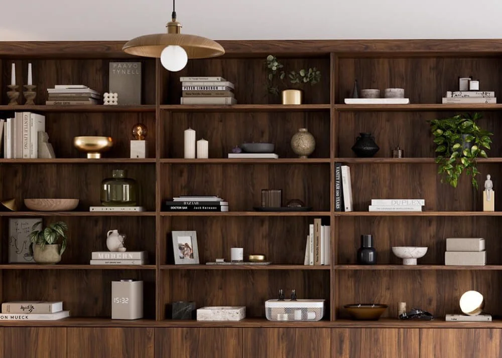 A large wooden bookshelf filled with decorative items, books, and plants, with a hanging light fixture above.