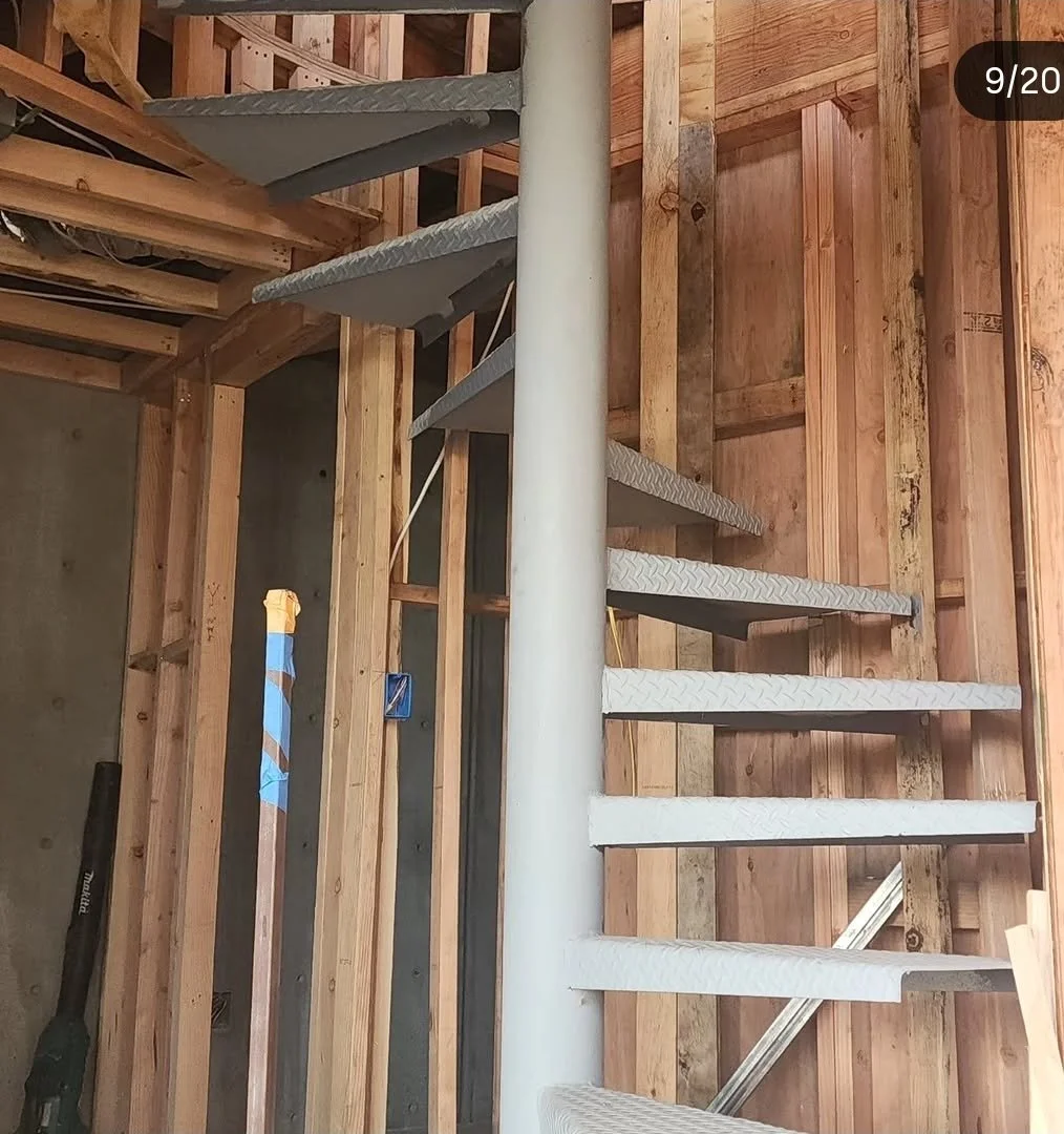 Spiral staircase with open wood framing before drywall, residential project in Brea, CA
