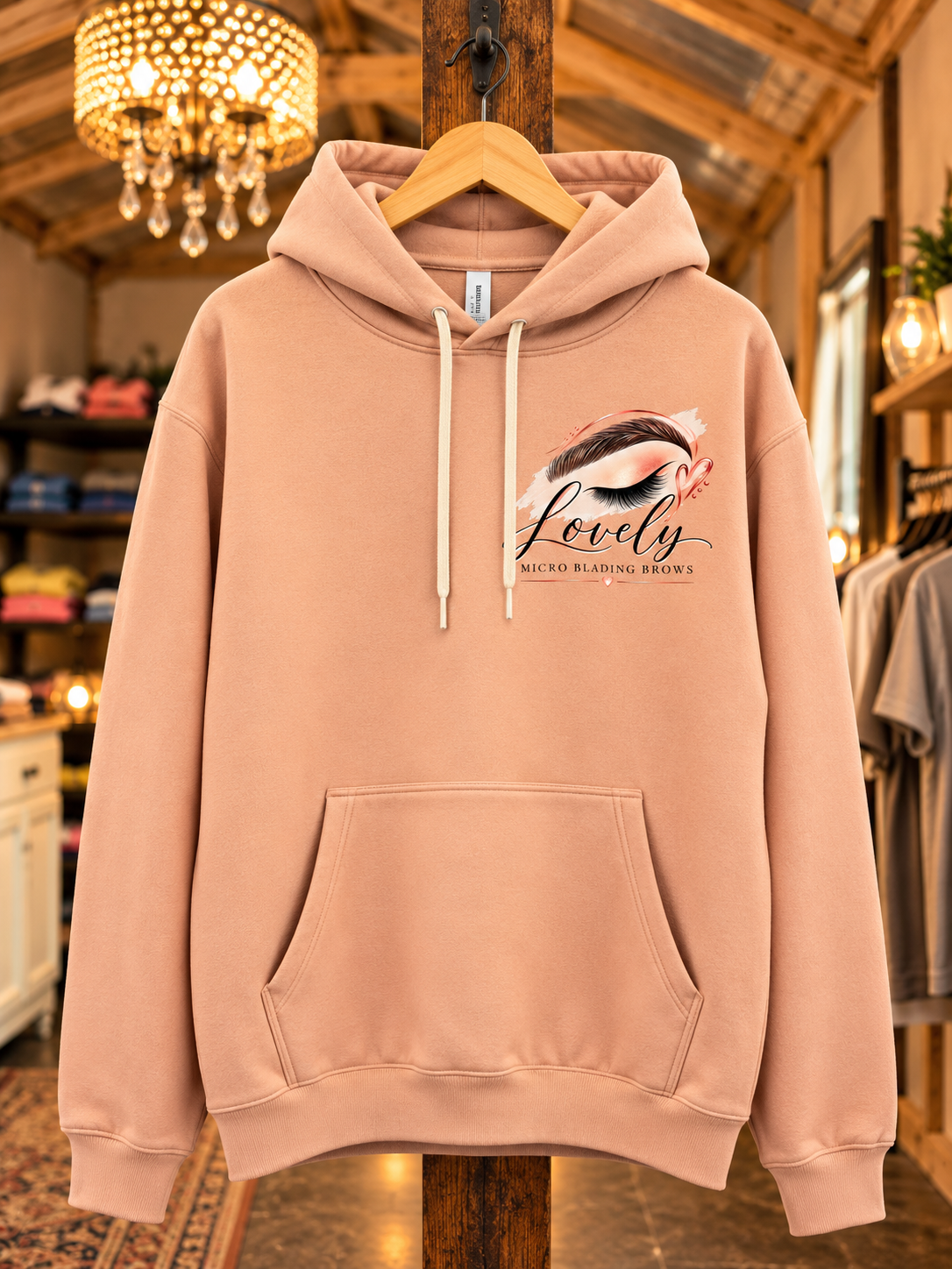 Peach pullover hoodie displayed on a wooden hanger in a boutique.