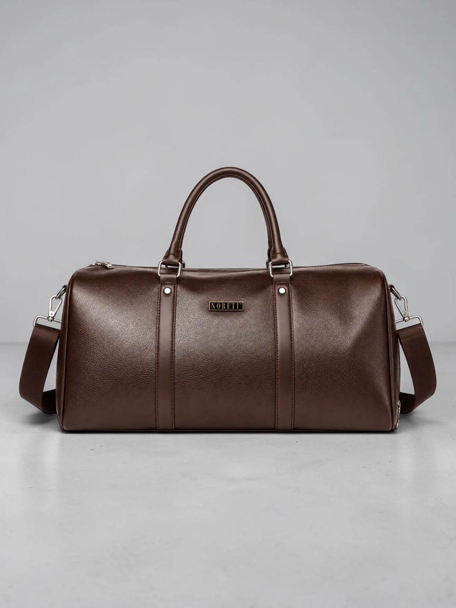 NORETI Ravelle Weekender in espresso brown premium vegan leather, featuring reinforced handles, shoulder strap and elegant design.