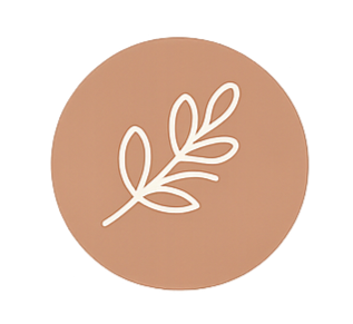 A round, beige-colored object with a white line drawing of a leaf on it.