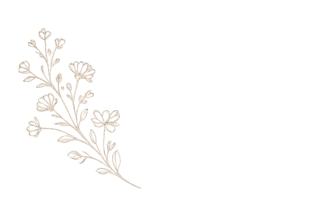 A white embroidered floral design on a black fabric background.