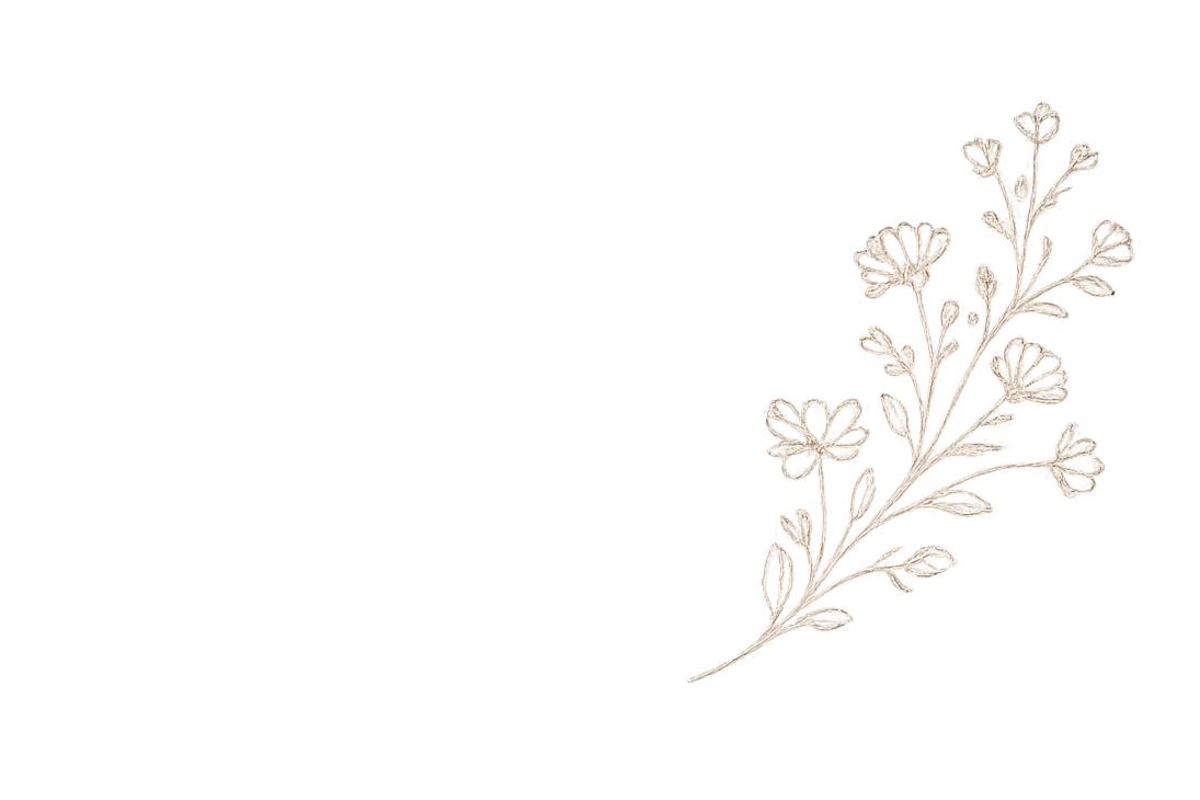 Decorative floral embroidery of a small white flower and leaves on black fabric