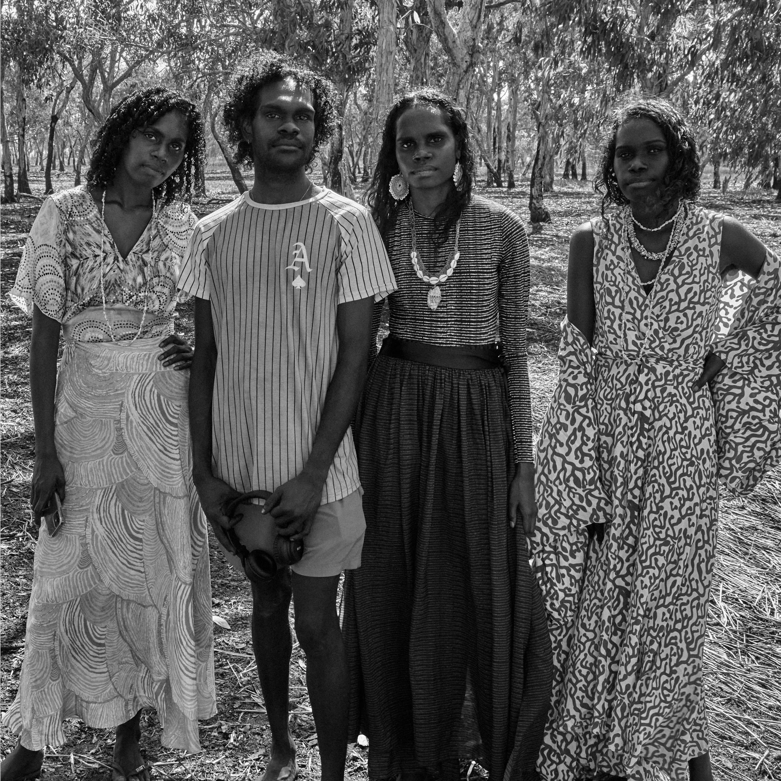 Tarlisa Gaykamangu and Jack Minmidhi standing with two First Nations models in a wooded setting during a ḺUNDU project.