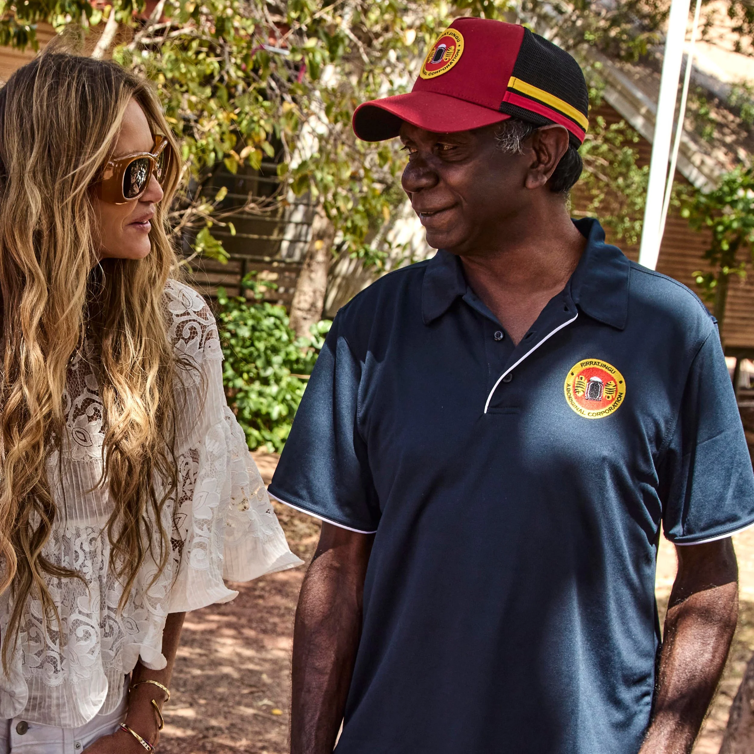 Elle Macpherson and a man standing together outdoors during a ḺUNDU project in East Arnhem Land.