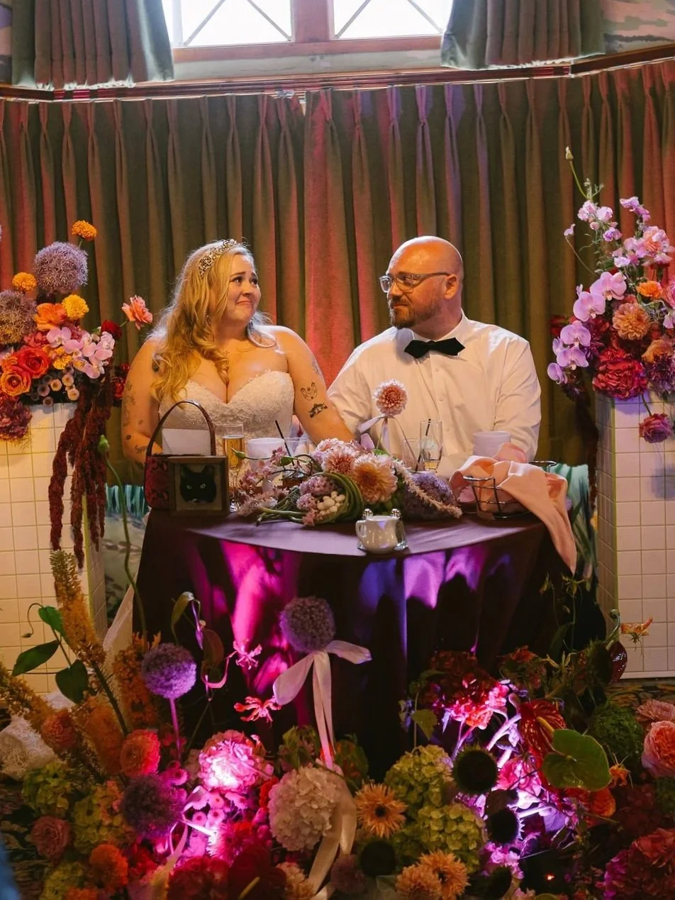 Newlyweds at sweetheart table at Madonna Inn, San Luis Obispo, CA