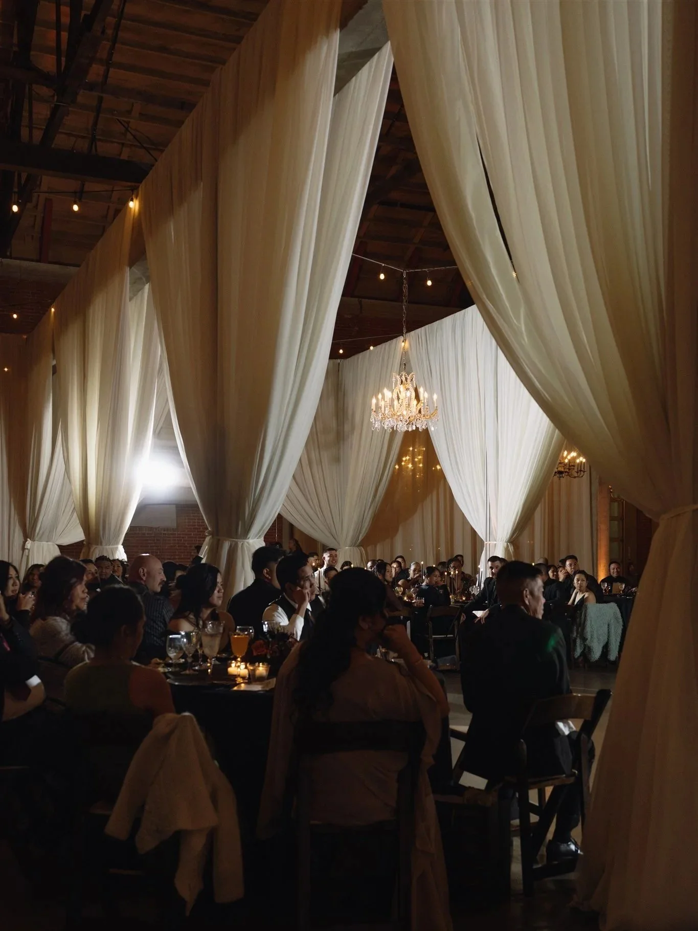 Indoor wedding reception with draping and chandeliers in Sacramento