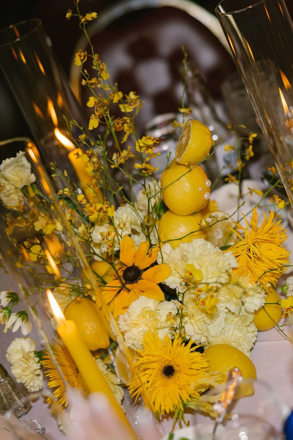 Unique yellow floral arrangement with lemons, flowers, pearls and candles 