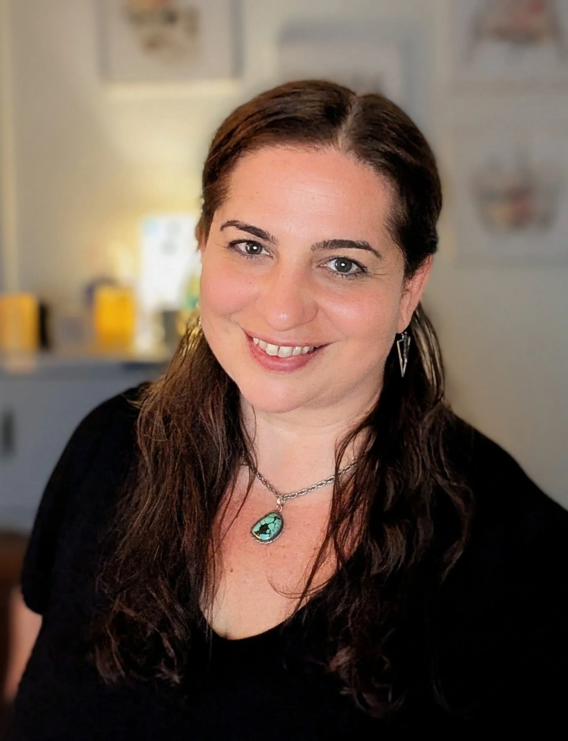 Rose Mollica Licensed Massage Therapist smiling in her studio.