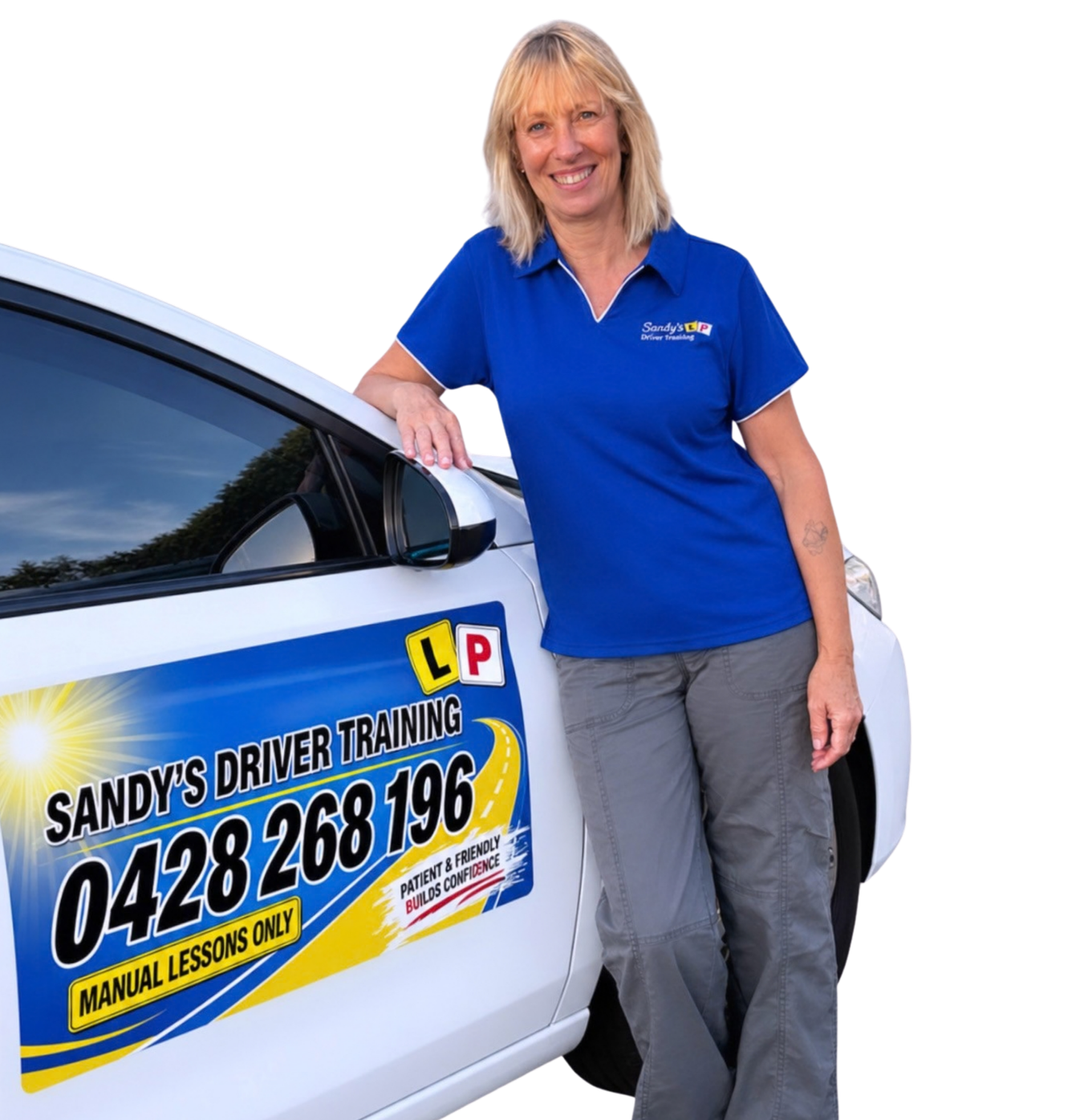A woman in a blue uniform standing next to a white car with a sign that reads 'Sandy's Driver Training' and a phone number. The woman is smiling, has blonde hair and a tattoo on her left forearm. The sign on the car advertises manual lessons only and emphasizes patient and friendly service that builds confidence.