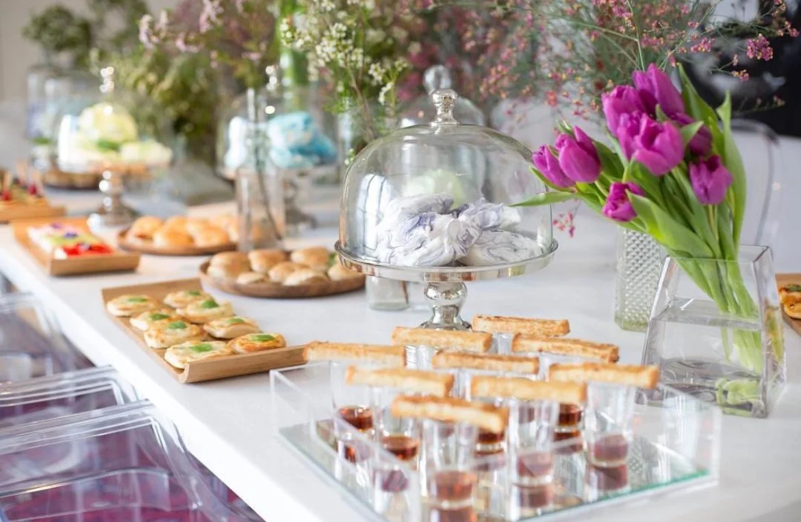Dessert table with tulips, shot glasses and glass cloche