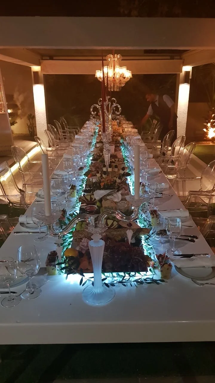 Candlelit private dining banquet table with grazing centrepiece