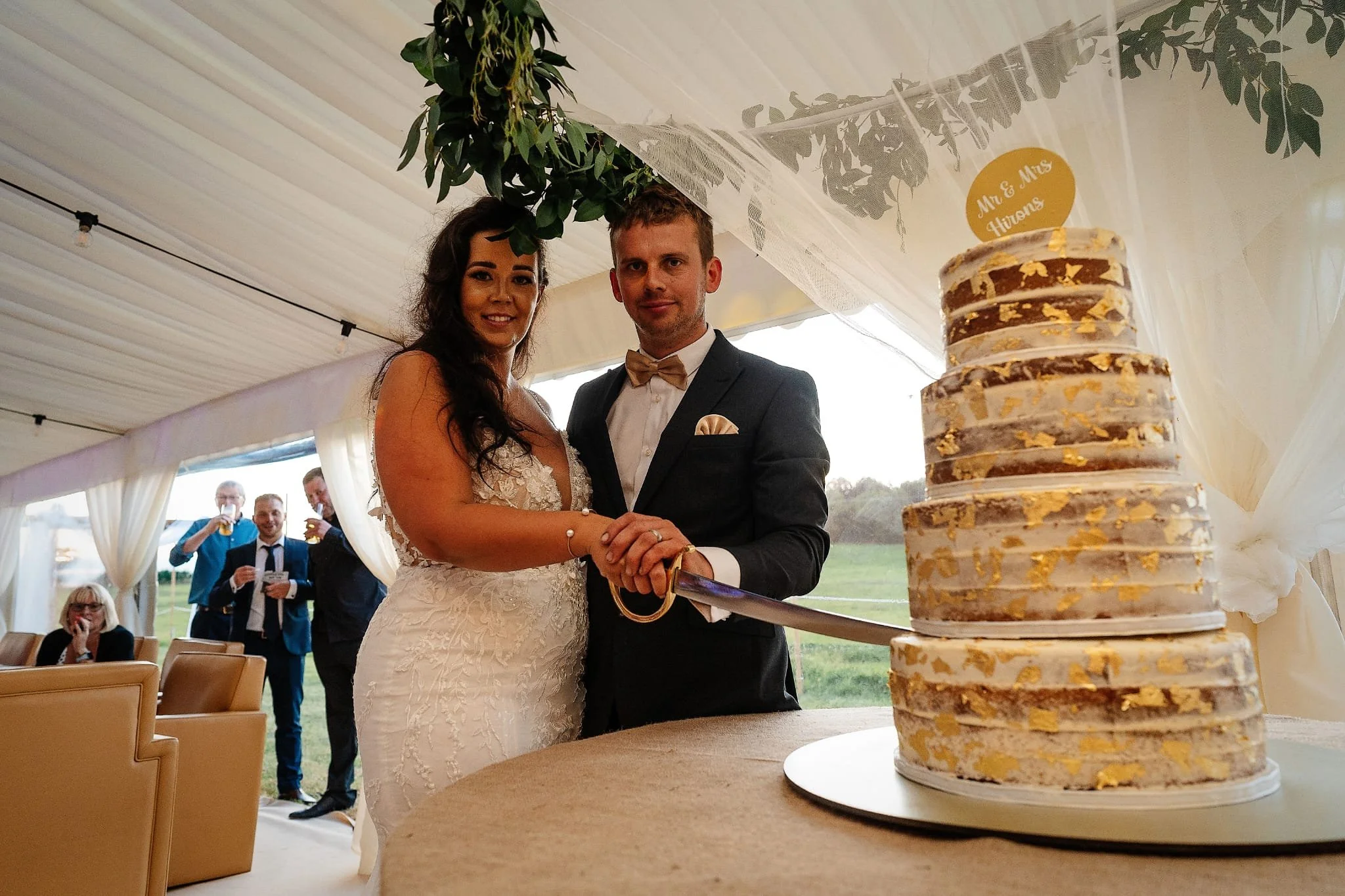 Bride and groom cutting a tiered wedding cake