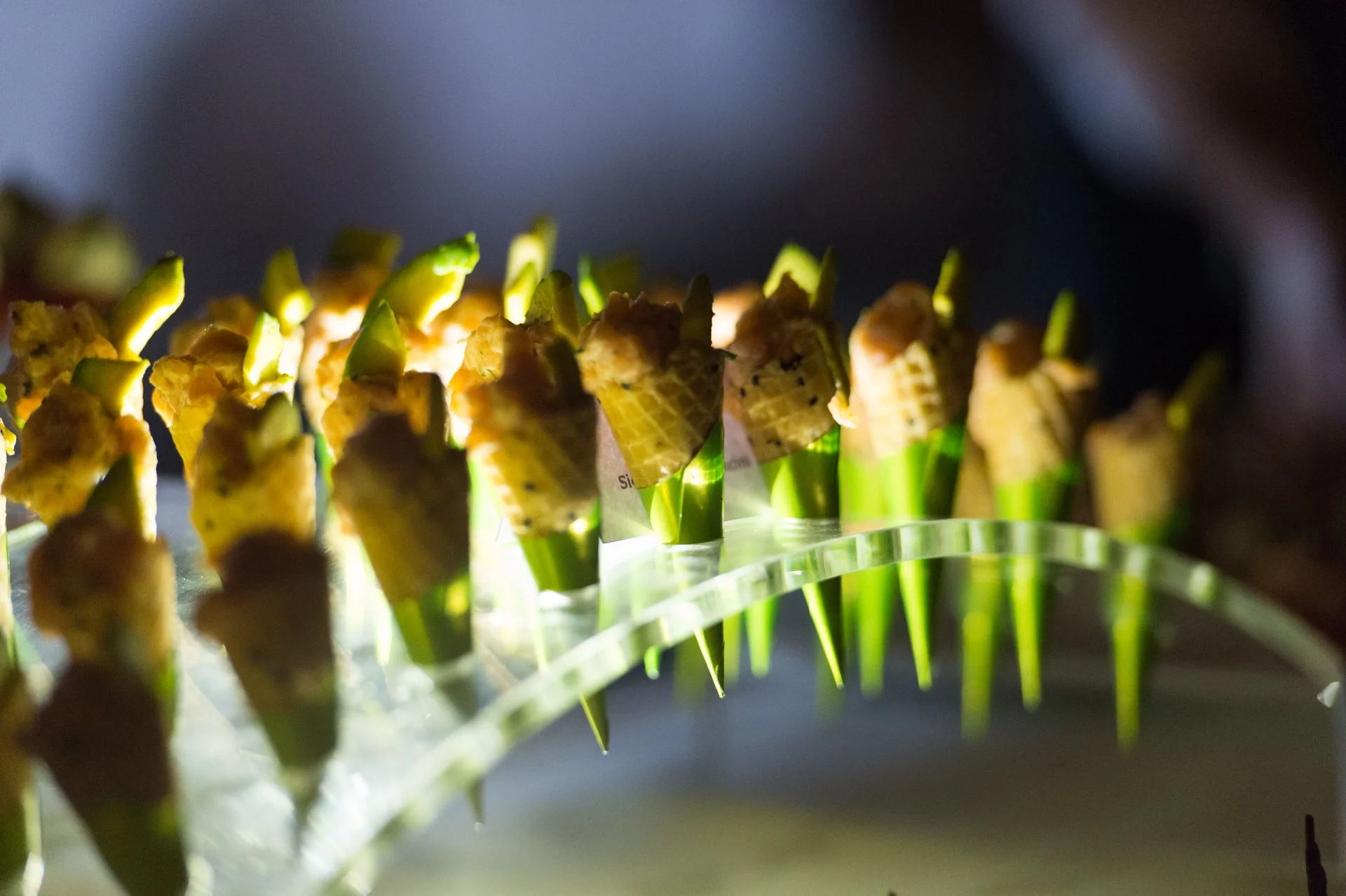 Cone canapés displayed on a glowing acrylic stand