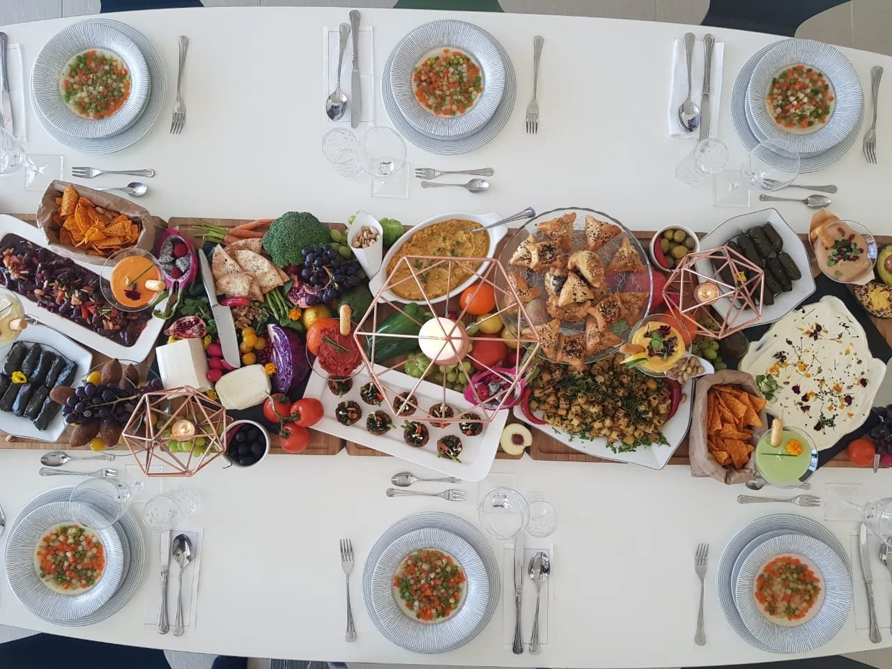Overhead view of a banquet table spread with sharing platters