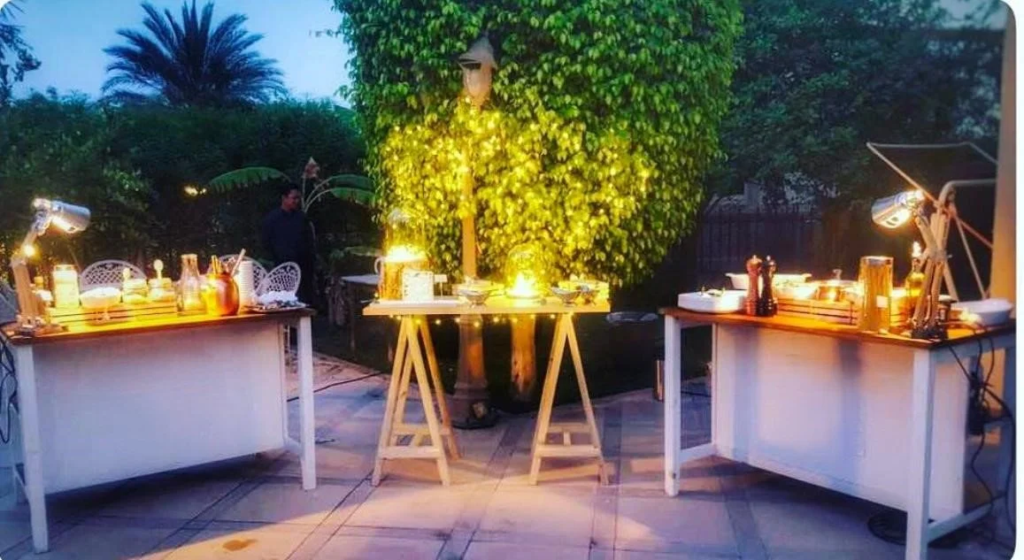Evening garden buffet tables lit by string lights