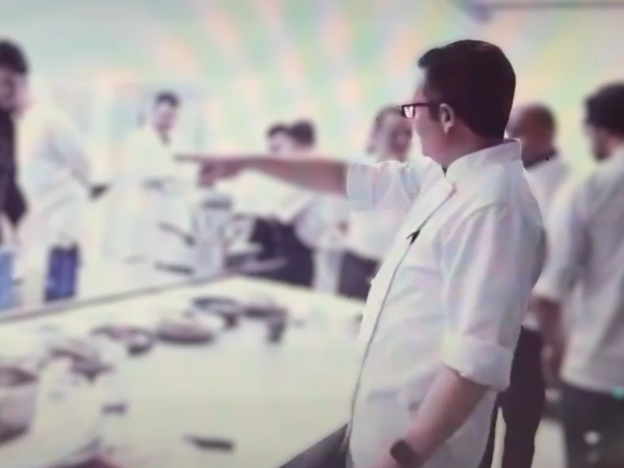 Chefs in whites at a culinary team training session