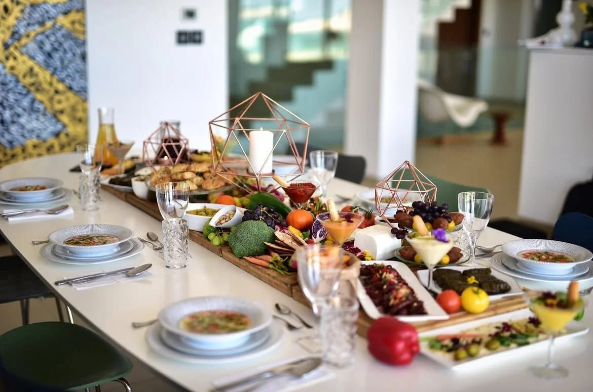 Dining table laid with bowls and a colourful sharing platter