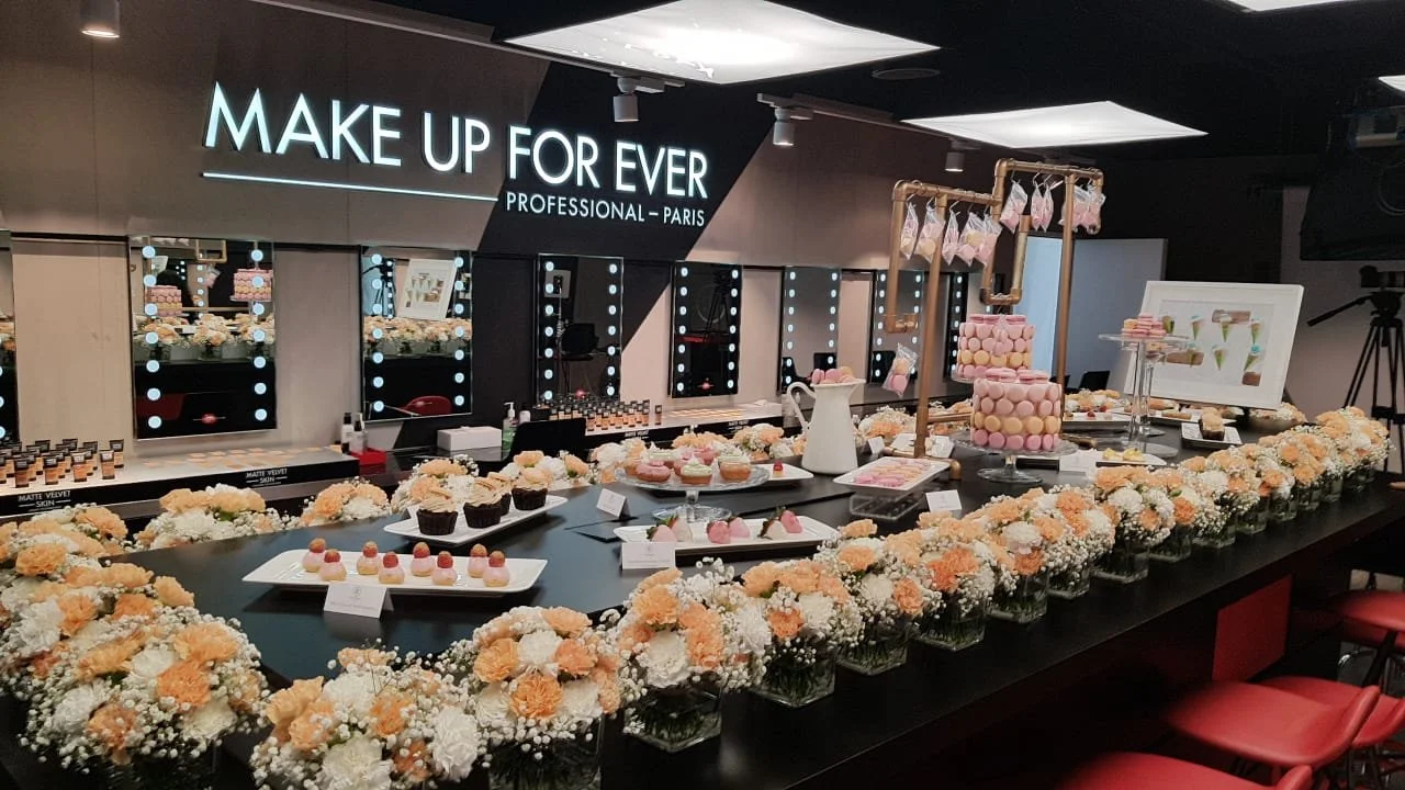 Dessert and macaron display at a Make Up For Ever event