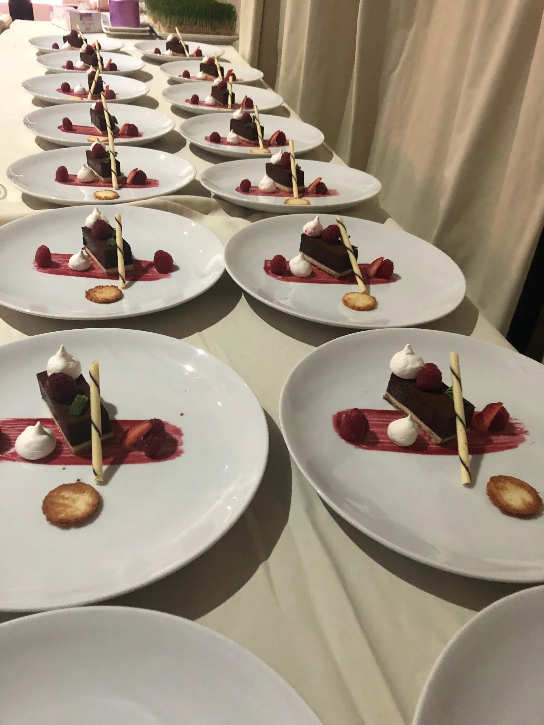 Rows of plated starters with beetroot lined along a table
