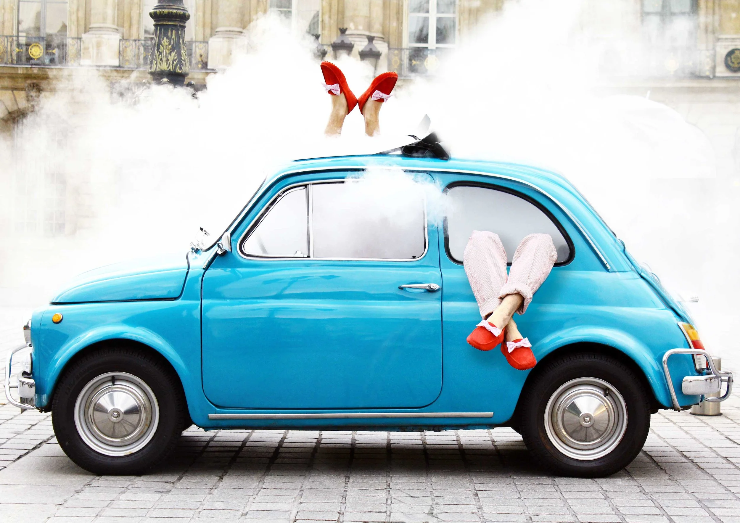 Une Fiat 500 d'époque place Vandôme, chaussures mocassins rouge sortant par les fenêtres et les toits et fumée .